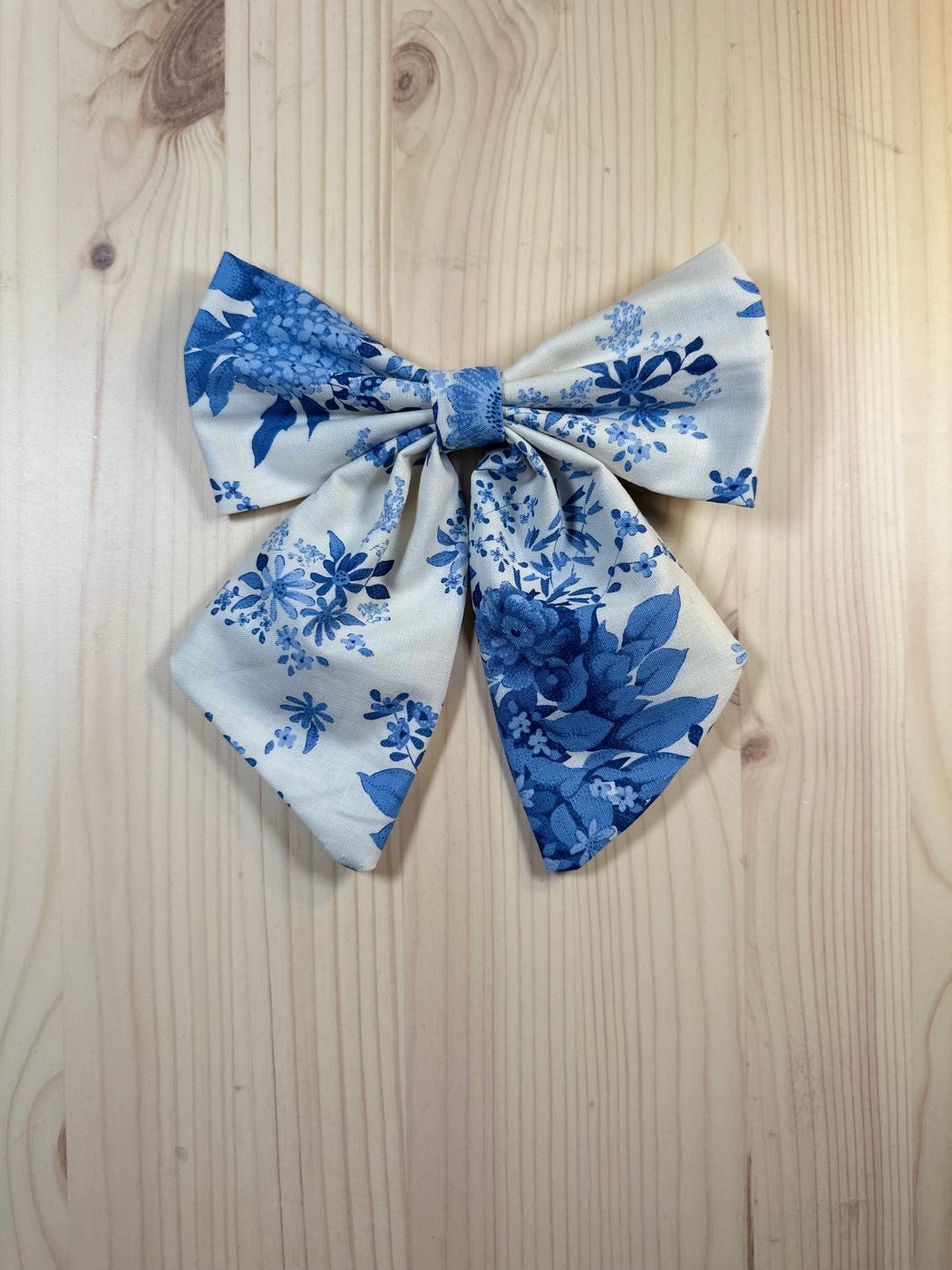 Handmade sailor bow in cream cotton with large cobalt-blue floral bouquets