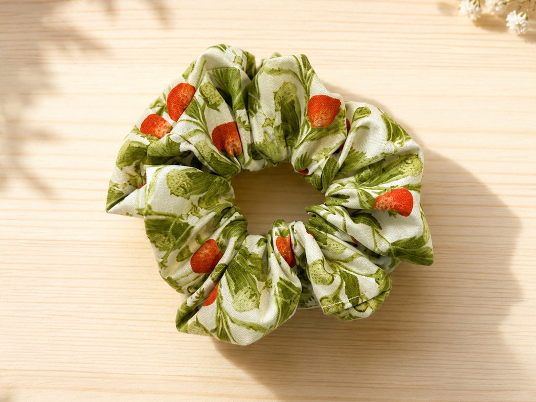 Handmade scrunchie in a red strawberry and green leaf print