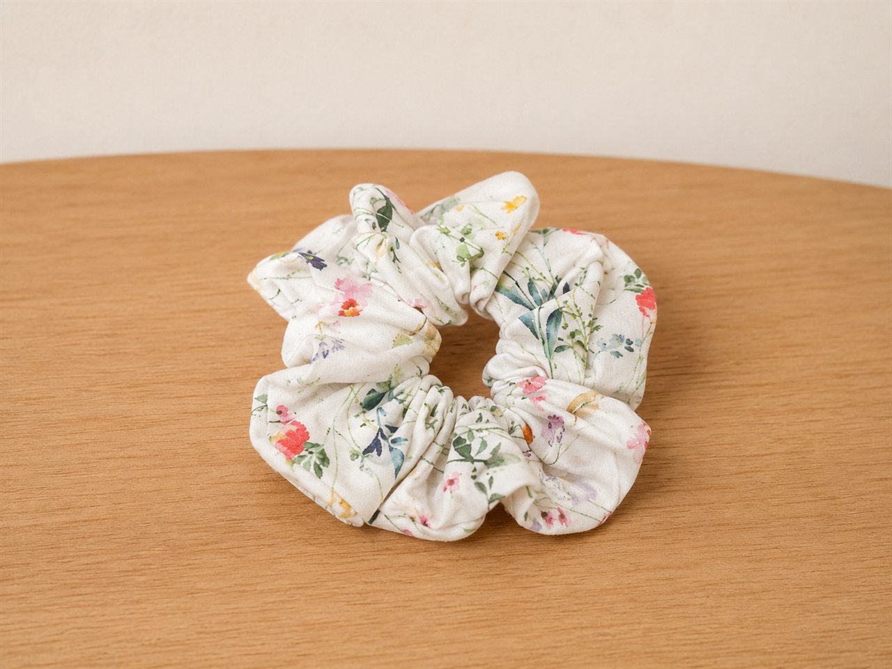 Handmade scrunchie in a tiny wildflower print on cream
